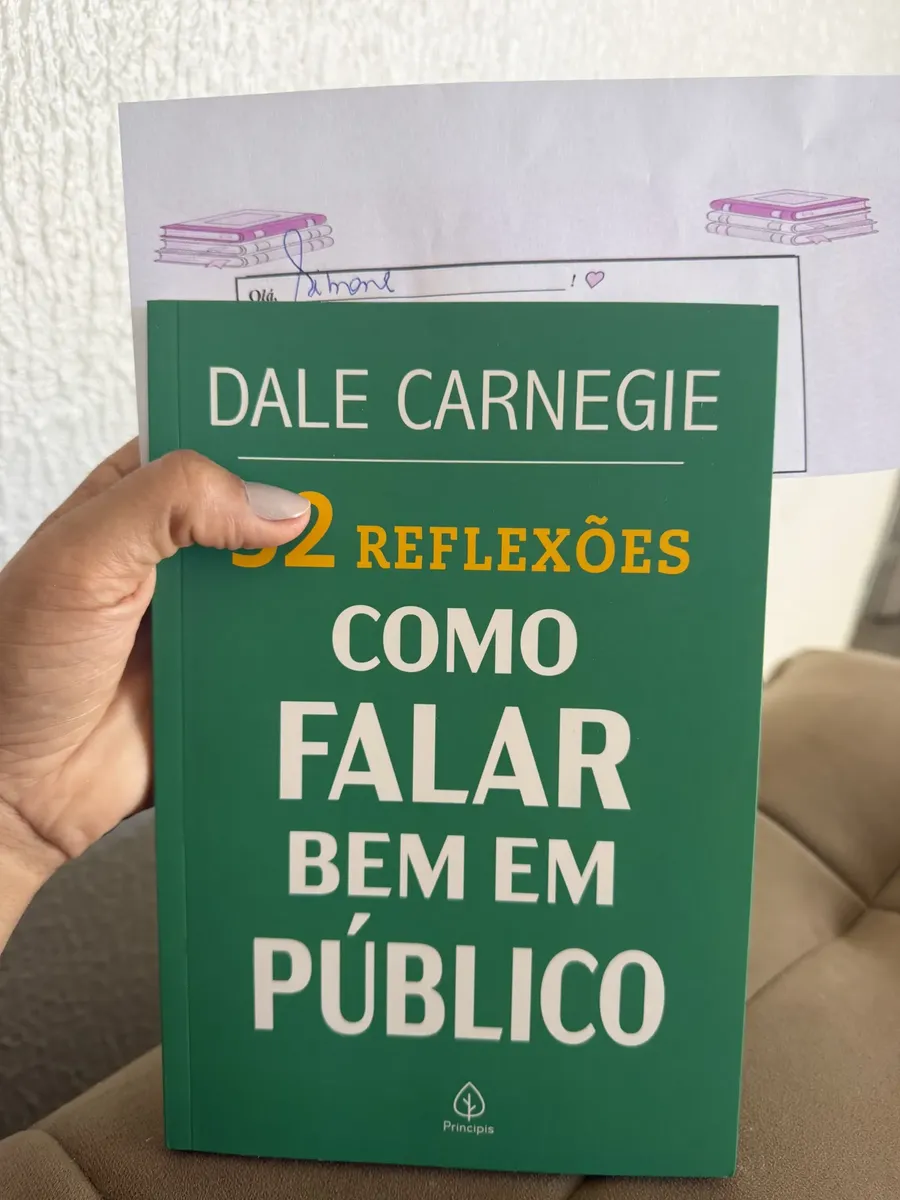 Foto de cliente segurando o livro na mão